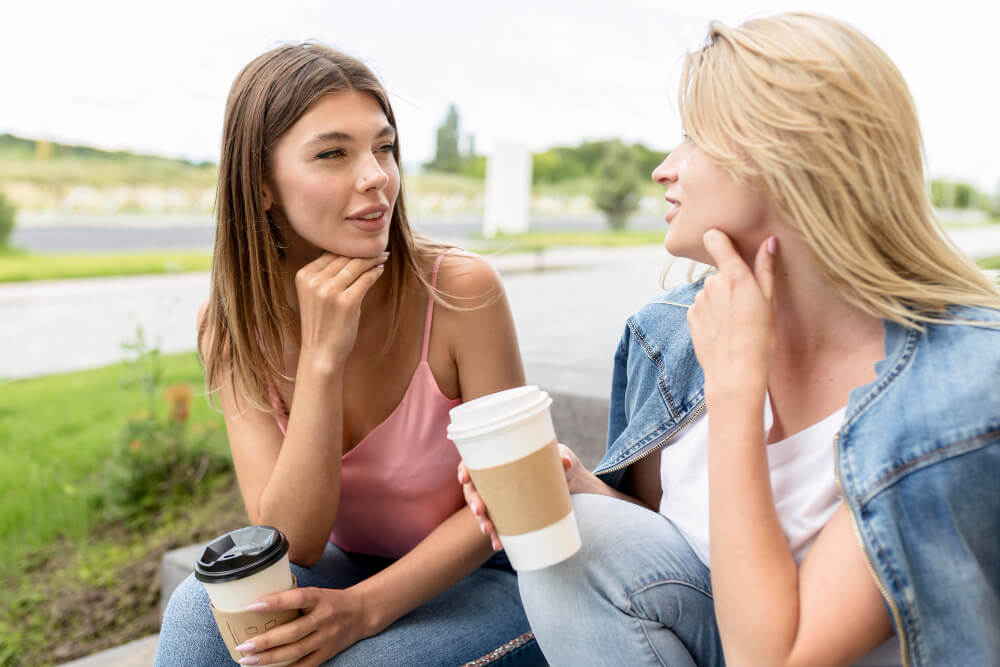 front view best friends holding some paper cups coffee 1